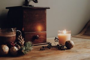 lighted candle beside brown wooden drawer